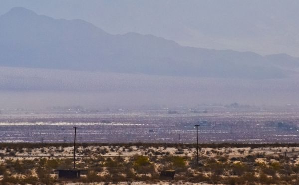 Dust in the air, dust kicked up by a passing vehicle, Wonder Valley, California.