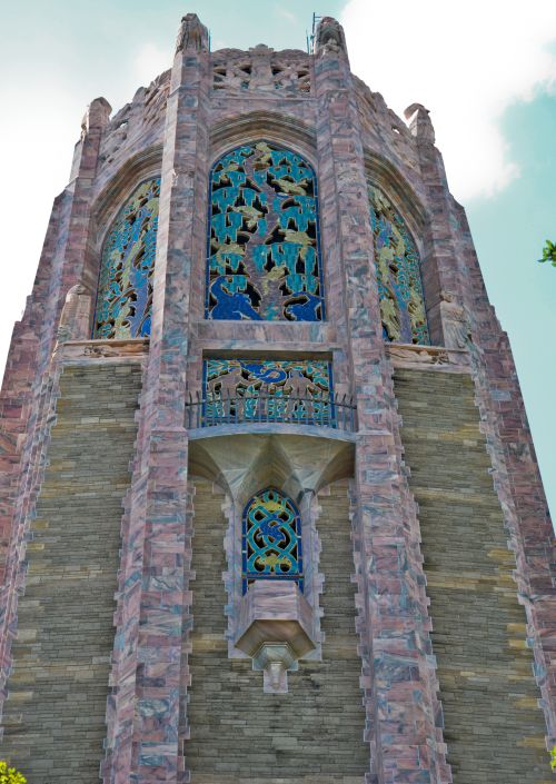 The top of Bok Tower looms overhead, as seen from the grassy lawn to the north of it.